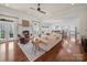 Living room with fireplace, neutral paint, hardwood floors, and ceiling fan at 3024 Beaver Dam Dr, Monroe, NC 28110
