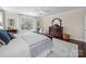 Bedroom featuring hardwood floors, a king bed, and large bright windows at 3024 Beaver Dam Dr, Monroe, NC 28110