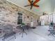 Spacious covered patio featuring brick accents, ceiling fans, and ample seating for relaxing or entertaining guests at 3024 Beaver Dam Dr, Monroe, NC 28110