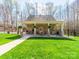 Inviting brick patio with comfortable seating, ceiling fans, and a built-in grill, perfect for outdoor entertaining at 3024 Beaver Dam Dr, Monroe, NC 28110