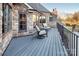 Spacious balcony with outdoor seating featuring stone and siding exterior and treed backyard views at 3200 Beaty Rd, Gastonia, NC 28056