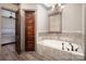 Elegant bathroom featuring a soaking tub with tile surround, chandelier, and access to the main bedroom at 3200 Beaty Rd, Gastonia, NC 28056