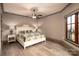 Cozy bedroom with hardwood floors, decorative ceiling fan, and a window allowing for natural light at 3200 Beaty Rd, Gastonia, NC 28056