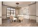 Spacious dining room with glass table, built-in cabinetry, and large windows at 3200 Beaty Rd, Gastonia, NC 28056