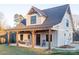 Charming home featuring a covered front porch with rocking chairs and classic architectural details at 3200 Beaty Rd, Gastonia, NC 28056
