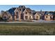 Stately stone and brick home featuring manicured landscaping and a circular driveway at 3200 Beaty Rd, Gastonia, NC 28056