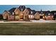Stately brick home with manicured lawn, stone accents, and an arched entryway at 3200 Beaty Rd, Gastonia, NC 28056