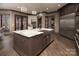 Kitchen island with marble countertops, double sinks and dark wood cabinetry at 3200 Beaty Rd, Gastonia, NC 28056