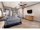 Bright main bedroom features a ceiling fan, hardwood floors, and a TV at 3200 Beaty Rd, Gastonia, NC 28056
