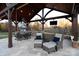 Luxury outdoor kitchen under a vaulted roof featuring a grill, bar, dining, and lounge area at 3200 Beaty Rd, Gastonia, NC 28056