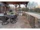 Stone outdoor kitchen under a vaulted roof featuring a grill, bar, dining area and stainless appliances at 3200 Beaty Rd, Gastonia, NC 28056