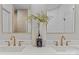 Elegant bathroom featuring double sinks with modern fixtures and decorative accents at 3324 Flamingo Ave, Charlotte, NC 28205