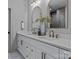 Modern bathroom with double sinks, bronze hardware, and decorative mirrors at 3324 Flamingo Ave, Charlotte, NC 28205