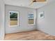 Bright bedroom with hardwood floors, neutral walls, and an array of windows overlooking the backyard at 3324 Flamingo Ave, Charlotte, NC 28205