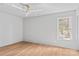 Bright bedroom with hardwood floors, neutral walls, and a large window overlooking the backyard at 3324 Flamingo Ave, Charlotte, NC 28205