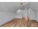 Spacious, well-lit bonus room with hardwood floors and a modern ceiling fan at 3324 Flamingo Ave, Charlotte, NC 28205