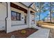 Inviting white brick front porch featuring a covered entry, stately columns, and manicured landscaping at 3324 Flamingo Ave, Charlotte, NC 28205