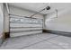 An open garage with concrete floors and a white door at 3324 Flamingo Ave, Charlotte, NC 28205