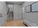 Hallway with wood floors, a staircase, and art pieces hanging on the wall at 3324 Flamingo Ave, Charlotte, NC 28205