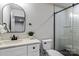 Modern bathroom features a white vanity, sleek mirror, and a glass-enclosed shower with black hardware at 3328 Flamingo Ave, Charlotte, NC 28205