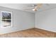 Inviting bedroom showcasing hardwood floors, a ceiling fan, and a large window with scenic views at 3328 Flamingo Ave, Charlotte, NC 28205