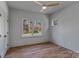 Cozy bedroom showcasing hardwood floors, a ceiling fan, and a large window with scenic views at 3328 Flamingo Ave, Charlotte, NC 28205