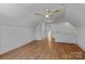 Bright bedroom featuring hardwood floors, a ceiling fan, and a window offering natural light at 3328 Flamingo Ave, Charlotte, NC 28205