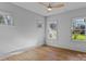 A spacious bedroom with hardwood floors, three windows, and a ceiling fan at 3328 Flamingo Ave, Charlotte, NC 28205
