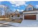 Charming two-story home with a light facade, well-manicured lawn, and a spacious driveway leading to an attached garage at 3328 Flamingo Ave, Charlotte, NC 28205