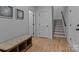 Hallway with hardwood floors, bench, and staircase at 3328 Flamingo Ave, Charlotte, NC 28205