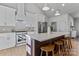 Modern kitchen with stainless steel appliances, white cabinets, quartz countertops, and a center island with seating at 3328 Flamingo Ave, Charlotte, NC 28205