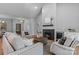 Beautiful open-concept living room with a fireplace, hardwood floors, stylish furniture, and access to dining area at 3328 Flamingo Ave, Charlotte, NC 28205