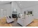 Bright living room featuring a cozy fireplace, hardwood floors, vaulted ceilings, and stylish neutral furniture at 3328 Flamingo Ave, Charlotte, NC 28205