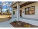 Inviting porch features painted brick, wooden door and ceiling, and manicured landscaping, enhancing curb appeal at 3328 Flamingo Ave, Charlotte, NC 28205