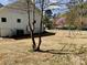 Exterior side yard of home surrounded by trees at 3328 Flamingo Ave, Charlotte, NC 28205