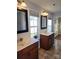 Bathroom featuring double sinks, framed mirrors, tiled floors, and two windows providing natural light at 3500 Exbury Gardens Dr, Waxhaw, NC 28173