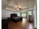 Spacious bedroom with hardwood floors, a tray ceiling, and lots of natural light from the windows at 3500 Exbury Gardens Dr, Waxhaw, NC 28173
