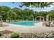 This community pool is framed by lounge seating, green trees, and a picnic shelter at 3500 Exbury Gardens Dr, Waxhaw, NC 28173