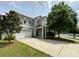 Charming two-story home with a well-manicured lawn, attached garage, and inviting covered porch at 3500 Exbury Gardens Dr, Waxhaw, NC 28173