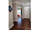 Inviting foyer with hardwood floors leading to a bright playroom through an arched entrance and a front door with sidelight at 3500 Exbury Gardens Dr, Waxhaw, NC 28173