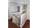 Hallway with hardwood floors, a baby gate, and access to other rooms, promoting safety and convenience at 3500 Exbury Gardens Dr, Waxhaw, NC 28173