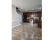 Open kitchen area with tile flooring, stainless steel appliances, dark cabinets, and seamless access to other living areas at 3500 Exbury Gardens Dr, Waxhaw, NC 28173