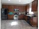 A kitchen featuring wood cabinets, stainless steel appliances, and tile flooring at 3500 Exbury Gardens Dr, Waxhaw, NC 28173