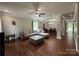 Open-concept living room with hardwood floors and a seamless transition to the adjacent dining area at 3500 Exbury Gardens Dr, Waxhaw, NC 28173