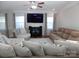 Cozy living room features a fireplace, ceiling fan, large windows, and comfortable seating for relaxing or entertaining at 3500 Exbury Gardens Dr, Waxhaw, NC 28173