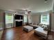 Spacious living room featuring hardwood floors, large windows, and a comfortable seating area at 3500 Exbury Gardens Dr, Waxhaw, NC 28173