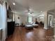 Open-concept living room with hardwood floors and a seamless transition to the adjacent dining area at 3500 Exbury Gardens Dr, Waxhaw, NC 28173