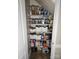 Organized pantry with multiple shelves stocked with clear containers, baskets, and various food items for ample storage at 3500 Exbury Gardens Dr, Waxhaw, NC 28173