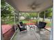 Covered patio with comfortable seating and a glass table, perfect for outdoor relaxation overlooking the landscaped yard at 3500 Exbury Gardens Dr, Waxhaw, NC 28173