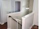 View of the staircase landing featuring neutral paint, white trim, and a safety gate at 3500 Exbury Gardens Dr, Waxhaw, NC 28173